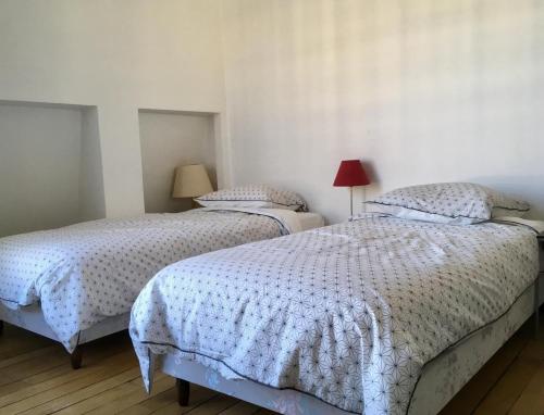 deux lits dans une chambre aux murs blancs dans l'établissement Sunny apartment in Paris Batignolles, à Paris