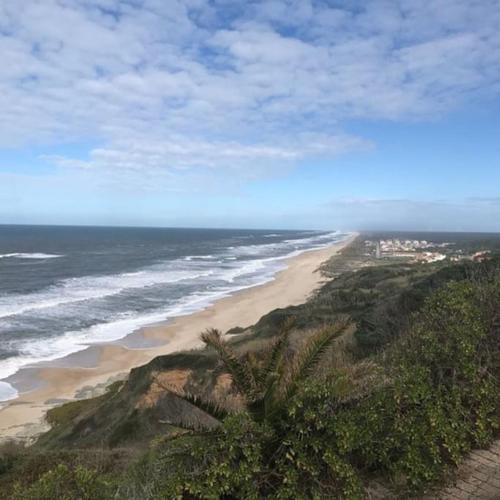 a view of a beach with the ocean at Casa de Praia Quiaios in Quiaios