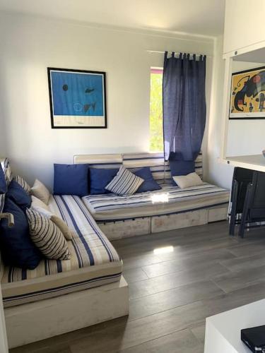 a living room with a couch and a window at Casa de Praia Quiaios in Quiaios