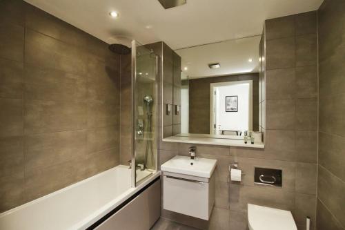 y baño con aseo, lavabo y espejo. en Seven Stays Modern Studio Apartment - Solihull, en Solihull