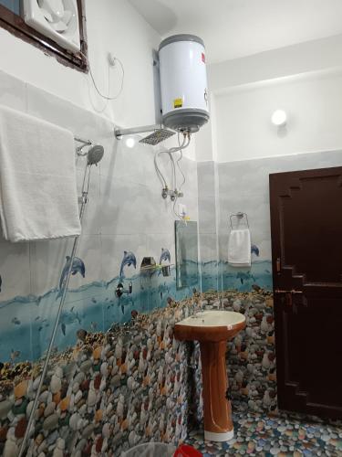 a bathroom with a sink and a shower at Hotel Tejas in Gupta Kāshi