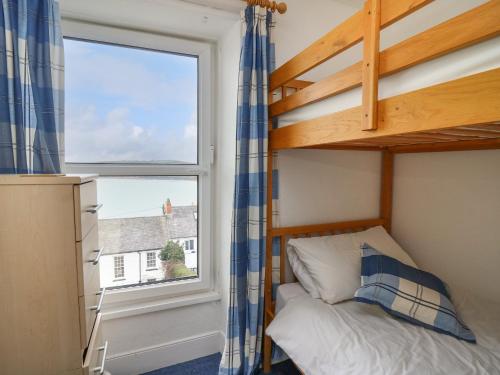 a bedroom with a bunk bed and a window at Ty-Clyd in New Quay