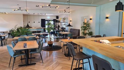 a restaurant with tables and chairs and a bar at Camping de Pallegarste Eco Villa 141 in Mariënberg