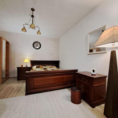 a bedroom with a bed and a clock on the wall at Unique Apartment Centar in Podgorica