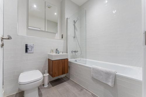 a white bathroom with a toilet and a sink at Contemporary 2 Bed Apartment Solihull NEC BHX in Solihull