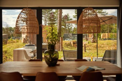 a wooden table with a vase on top of it at Dutchen Zeegser Duinen Villalodges in Zeegse