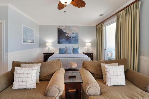 a hotel room with a bed and two couches at 13th Perfection in Tybee Island