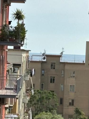 an apartment building with a palm tree on the balcony at La Bella Salernitana in Salerno