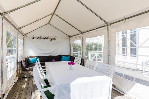 a dining room with a table and chairs in a marquee at Nice house with a panoramic view of the sea on beautiful Hasslo outside Karlskrona in Karlskrona