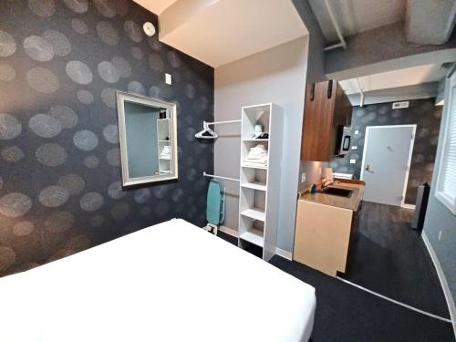 a room with a kitchen with a counter and a room with at Enjoy Spring Time In Boston 406 in Boston