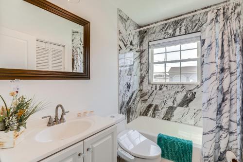 a bathroom with a sink and a toilet and a mirror at Atlantic City Home with Gas Grill Near 8 Beaches! in Atlantic City