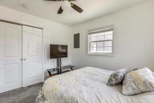 a bedroom with a bed with a ceiling fan and a television at Atlantic City Home with Gas Grill Near 8 Beaches! in Atlantic City