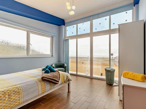 a bedroom with a bed and a view of the beach at 3 Bed in Tenby 60757 in Tenby