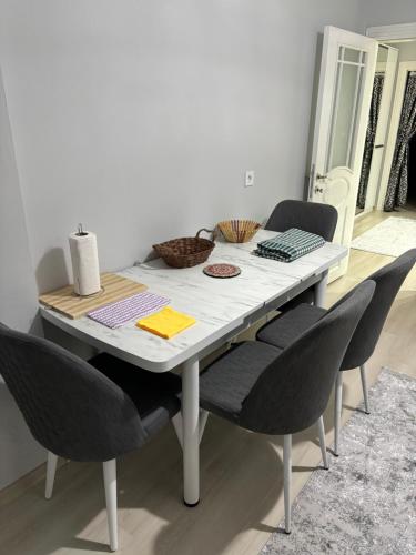 a dining room table with chairs around it at Seafront Apartment Rize-Ardeşen in Ardeşen