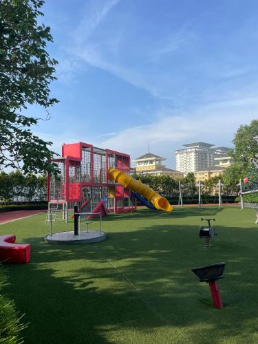 a playground with a yellow slide in a park at The Ridge KL East in Kuala Lumpur