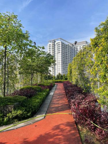 a pathway in a park with a building in the background at The Ridge KL East in Kuala Lumpur