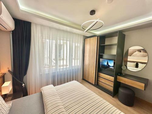 a bedroom with a bed and a television in it at Tomtom HOUSE Centre Location in Istanbul