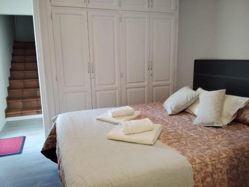 a bedroom with a bed with white pillows on it at Casa Cal Gansoleta in La Coma i la Pedra