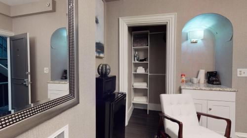 a mirror on a wall next to a white kitchen at L 3-33 Stylish Private Studio in Boston! in Boston