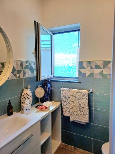 a bathroom with a sink and a window at Sosò Art b&b in Positano