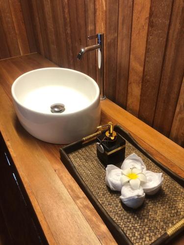a bathroom with a sink and a tray with a white sink at The Tropical Koh Mook in Koh Mook