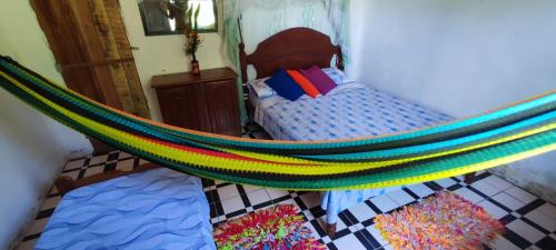 a bedroom with a bed and a hammock at Eco Hostel Lunar in Soure