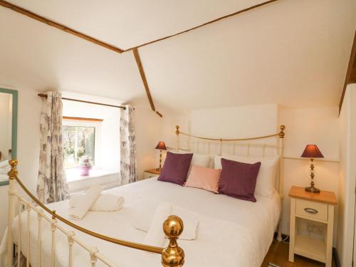 Un pat sau paturi într-o cameră la Tiddlers Cottage