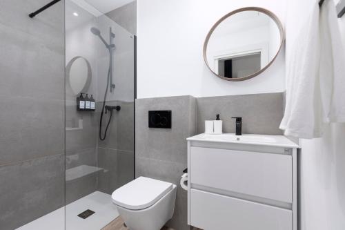 a bathroom with a toilet and a sink and a mirror at La Lajita Barca Beach Sand in La Lajita