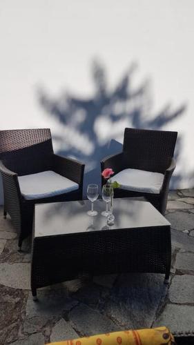 two chairs and a table with a wine glass at Un piccolo Paradiso nel Chianti più selvaggio in Greve in Chianti