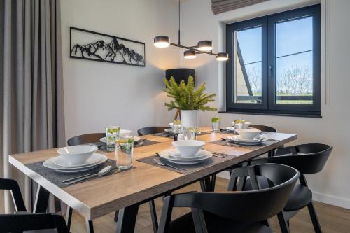 a dining room with a wooden table and chairs at Silent Mountain in Bukowina Tatrzańska