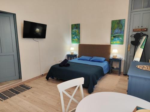 a bedroom with a bed and a tv on the wall at Charming studio in Tazacorte in Tazacorte