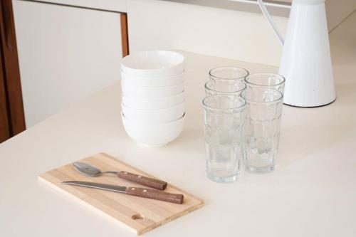 a table with glasses and a cutting board and scissors at Welcome to Villa Cristy 3-BR 3 5-WC in the La Floresta area in Ajijic