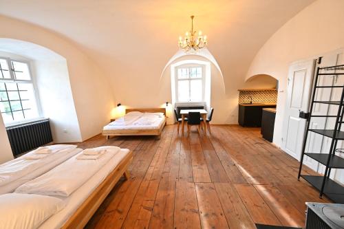a large room with two beds and a desk at Zámecká lesovna in Valeč
