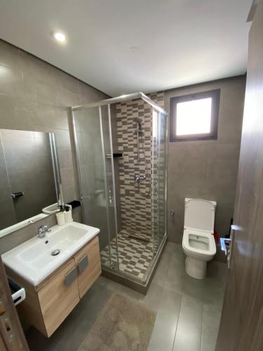 a bathroom with a shower and a toilet and a sink at Smir Park,Tetouan in Marina Smir