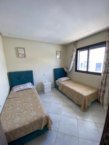 a bedroom with two beds and a window at Smir Park,Tetouan in Marina Smir
