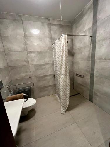 a bathroom with a shower and a toilet at Beztroska Zatoka - agroturystyka Jacuzzi & Sauna in Połajewo