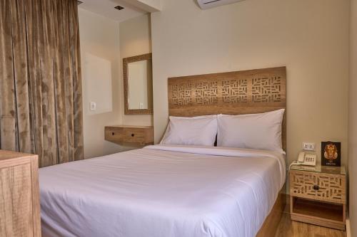 a bedroom with a white bed and a window at Lotus Inn in Cairo