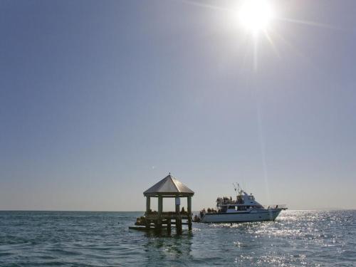 a boat with a gazebo in the water at Brilliant Port Melbourne Central Townhouse in Melbourne