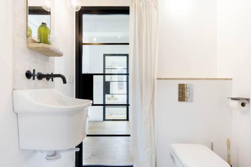 une salle de bain blanche avec des toilettes et un lavabo dans l'établissement Appartement terrasse au cœur d'Aix-en-Provence #2, à Aix-en-Provence