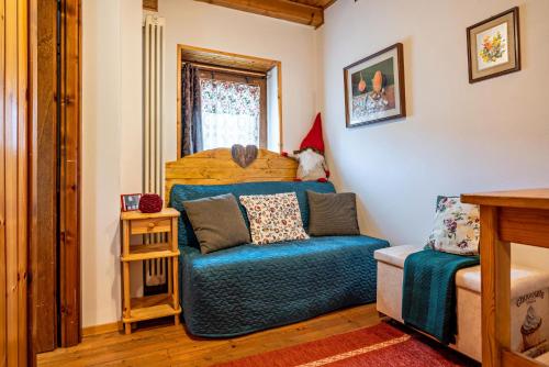 a bedroom with a bed and a blue couch at La casa di Ketty in Bieno