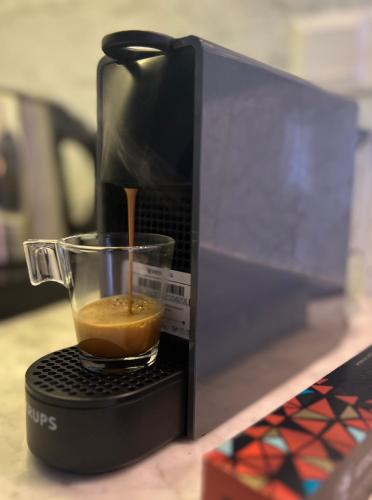 a coffee maker is making a cup of coffee at PortaDelMare deluxe suites in Hydra