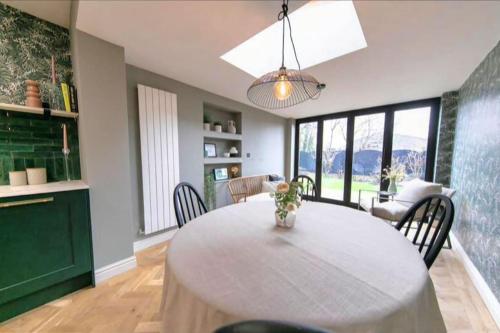 a kitchen and dining room with a table and chairs at Beautifully styled Home with Garden in Poulton le Fylde