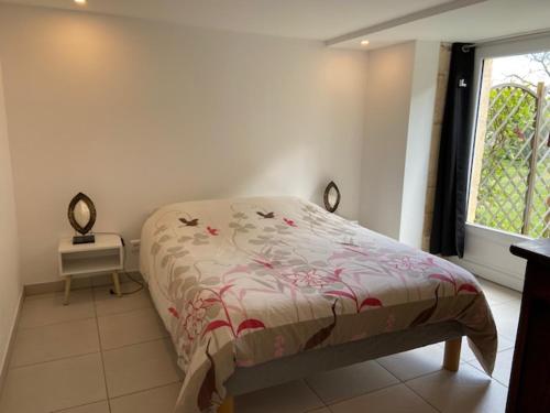 a bedroom with a bed and a window at La Requeyrie in Montignac
