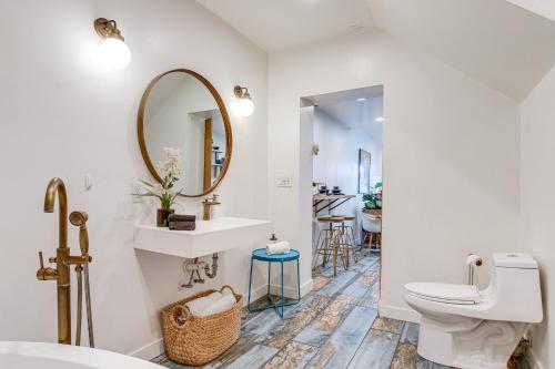 a bathroom with a toilet and a sink and a mirror at Denver Tiny House Walk to Cafes, Bars, Eateries! in Denver