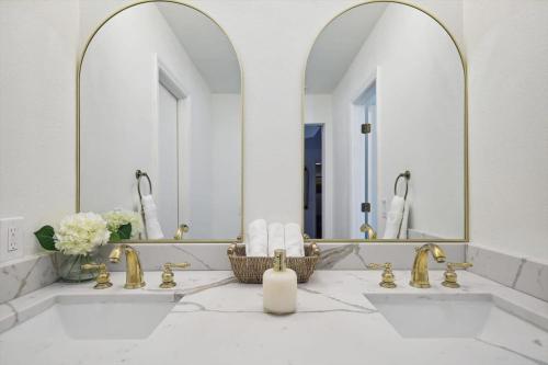 a bathroom with two sinks and two mirrors at Allen Abode - 4 Bedrm Pool Fire Pit Charm in Allen