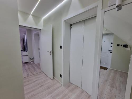 an empty hallway with white walls and wood floors at MI 5 in Ruse