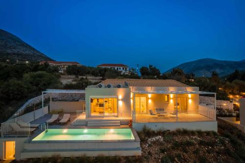 a house with a swimming pool in front of it at Levantes Villa in Divarata