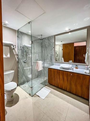 a bathroom with a shower and a toilet and a sink at Spectacular Ocean front 5BR condo in Bolongo in Punta Mita