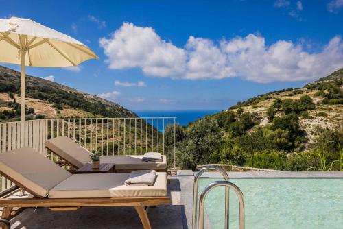 a pool with a chair and an umbrella next to a swimming pool at Punentes Villa in Divarata