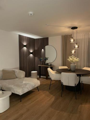 a living room with a table and a couch and a dining room at KG Apartment in Hannover